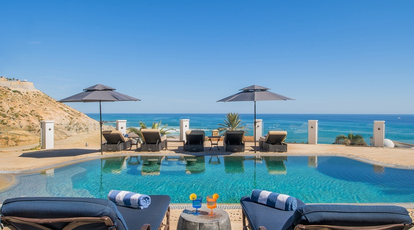 Sunny poolside patio overlooking an incredible ocean view