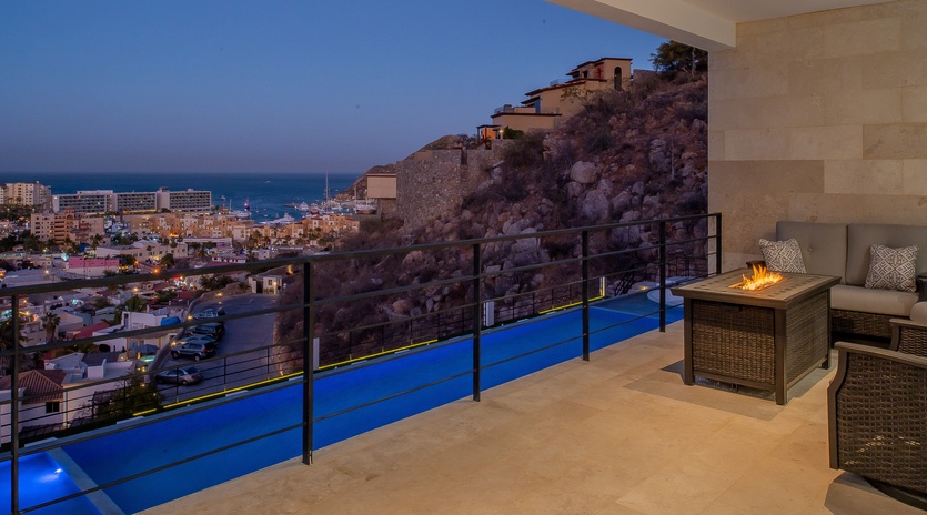 Terrace with city and ocean view at night