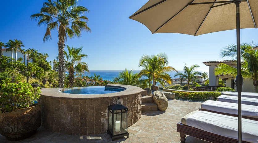 Sunny patio with jacuzzi and ocean views