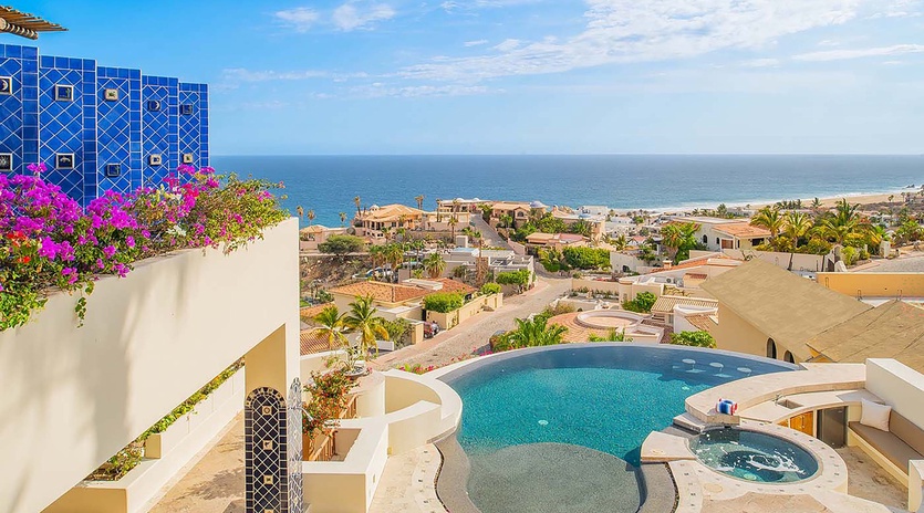 A stunning coastal oasis awaits you—this private pool and hot tub sit framed by lush bougainvillea and sweeping ocean views, offering the perfect setting for your sun-soaked escape.