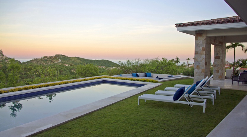 Pool with ocean view during sunset
