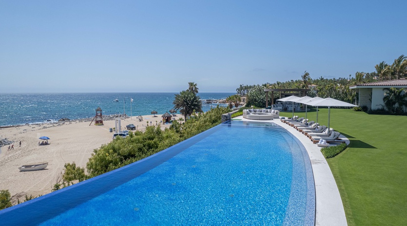 Infinity pool with beachfront views