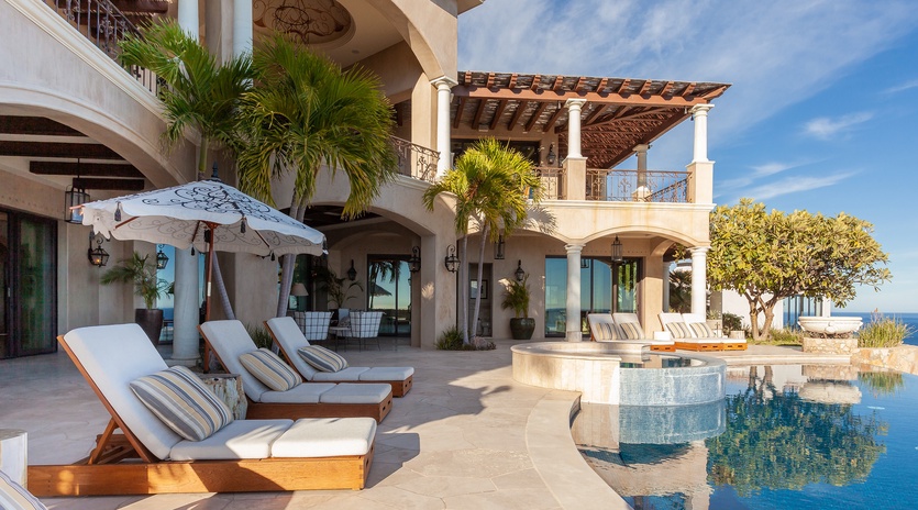 Lounge by the poolside with ocean views