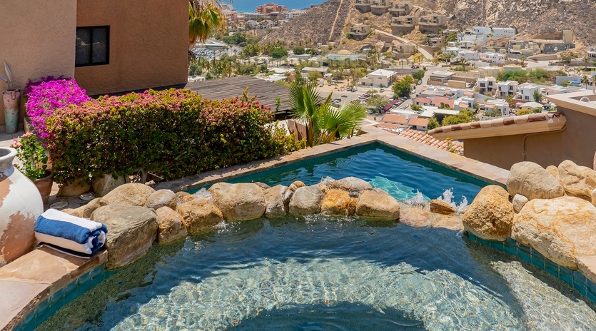 Stone patio with sun deck and pool