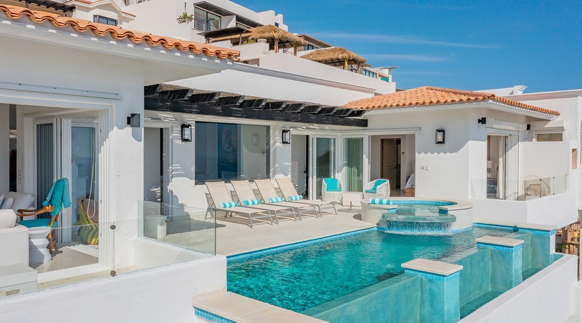 Poolside view of the patio and exterior of villa