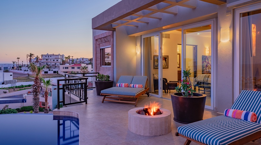 Lounge by the poolside next to a nice cozy fire pit