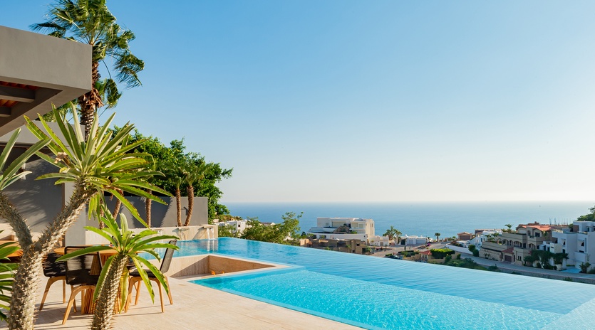Sunny patio with infinity pool and ocean view