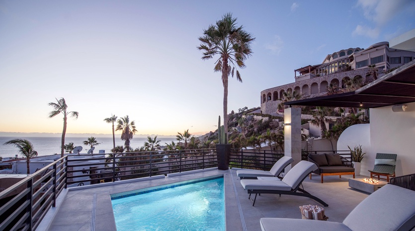Poolside deck with lounge chairs and ocean views