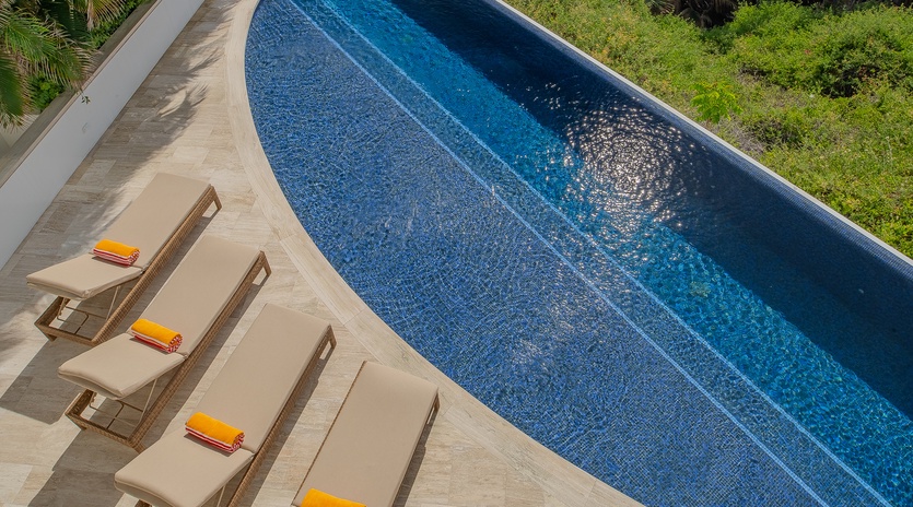 Dive into your own private paradise with this stunning pool surrounded by lush tropical gardens and comfortable loungers perfect for soaking up the sun.