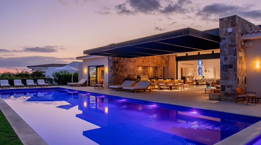 Poolside view of exterior during sunset