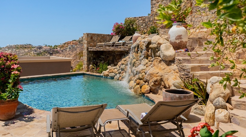 Stone patio with sun deck and pool