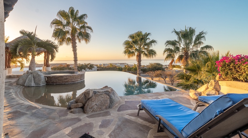 Infinity pool and jacuzzi with ocean views during sunset