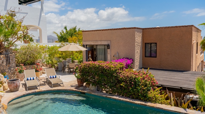 Stone patio with sun deck and pool