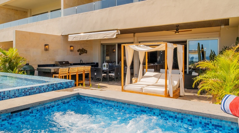 Poolside view of patio and canopy bed