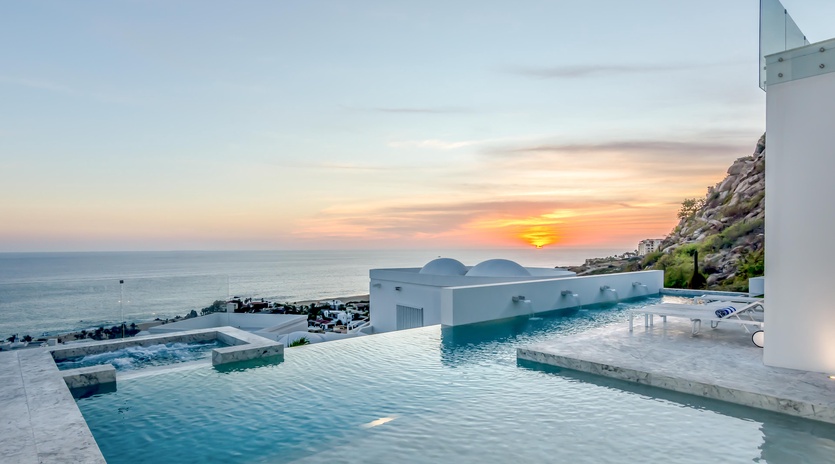 Stunning infinity pool captures the perfect sunset over the sea, creating an unforgettable evening backdrop for your stay.