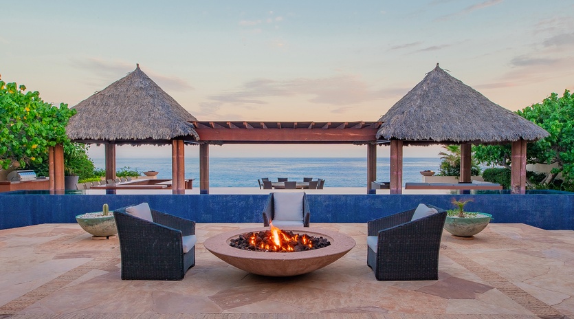 Poolside patio with fire pit and ocean views
