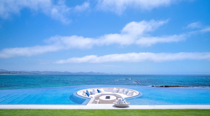 Patio with fire pit and infinity pool with ocean views