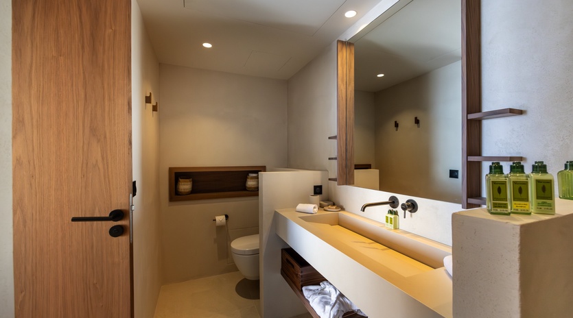 Unwind in this modern bathroom featuring a luxurious soaking tub, premium amenities, and sleek design that transforms your daily routine into pure relaxation.