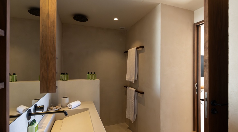 Your modern bathroom features warm wood accents, premium amenities, and a sleek walk-in shower for ultimate comfort.