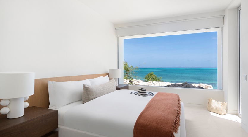 Wake up to pristine turquoise waters stretching to the horizon from your serene bedroom sanctuary.