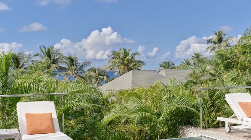 Relax poolside surrounded by swaying palms and endless blue skies in your own tropical paradise.