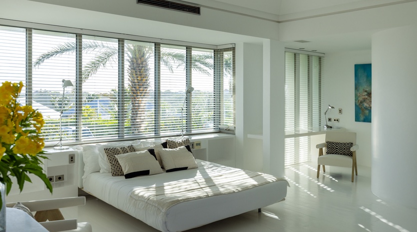 Drift off in your sun-drenched bedroom with tropical palm views, where crisp white linens and gentle breezes create pure serenity.