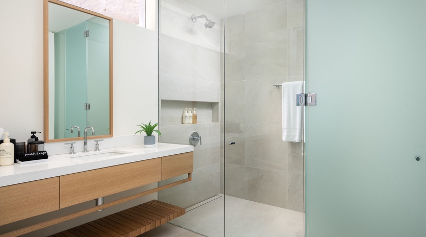 Unwind in your spa-like bathroom featuring a spacious walk-in shower with rainfall head and elegant floating vanity.