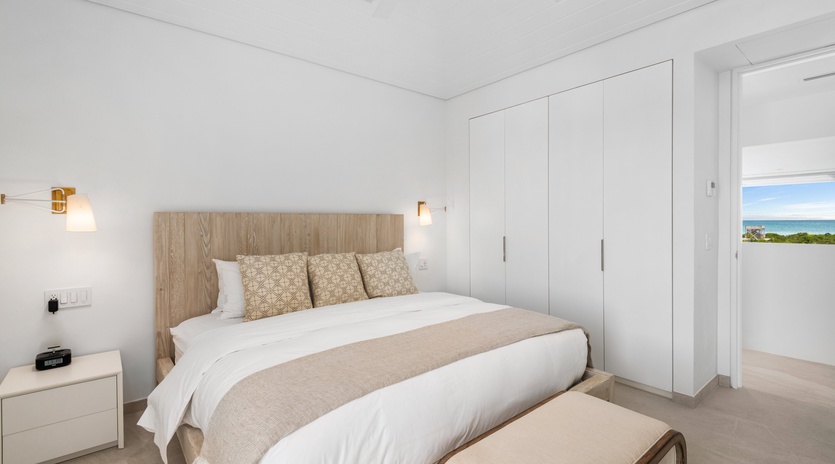 Rest peacefully in your bright bedroom with ocean glimpses through the window and ample wardrobe space for your vacation wardrobe.