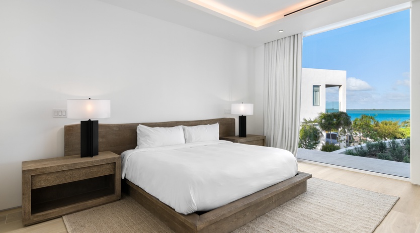 Wake to stunning ocean views from your luxurious bedroom, where crisp linens and elegant furnishings create your perfect retreat.