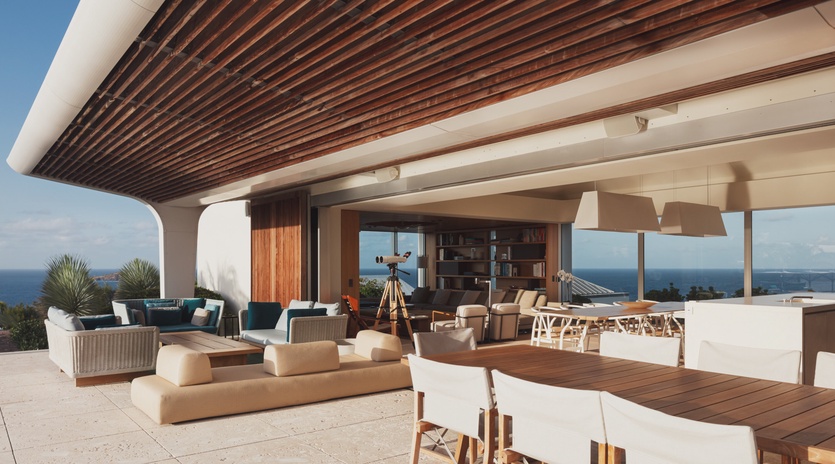 Sprawling ocean-view terrace with modern seating and dining areas creates your perfect outdoor retreat.