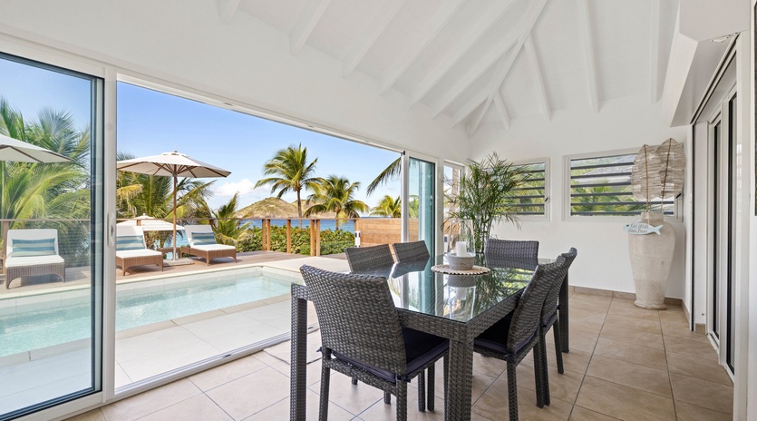 Your private dining space opens to tropical paradise views, where your pool meets ocean breezes and swaying palms.