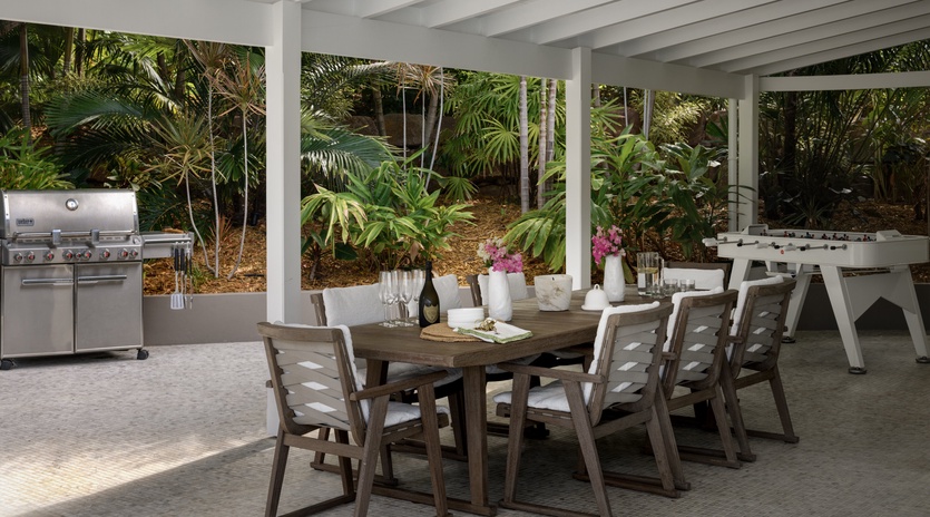 Savor meals in your covered outdoor dining area with premium BBQ and tropical garden views.