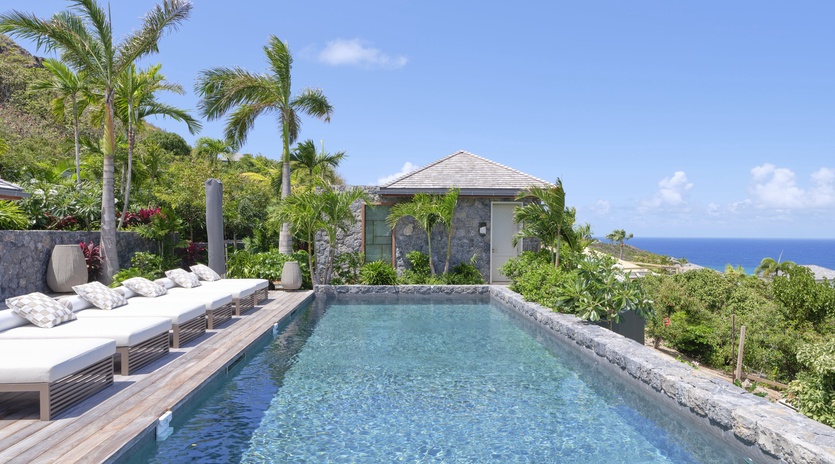 Your private infinity pool overlooks azure waters, surrounded by swaying palms and tropical gardens. Pure paradise awaits.