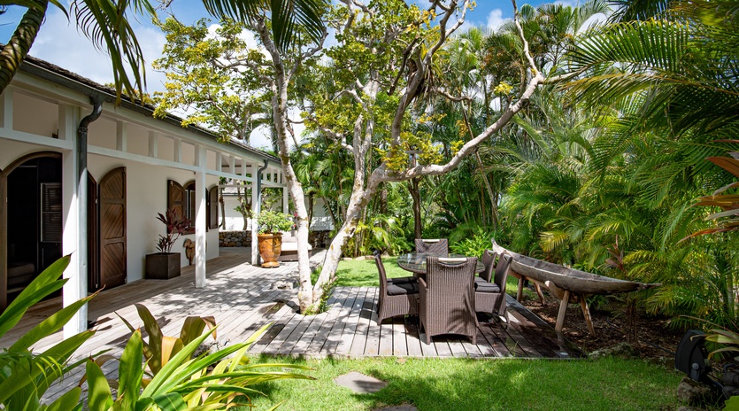 Step onto your private deck surrounded by swaying palms and tropical gardens, where shaded seating invites you to unwind in paradise.