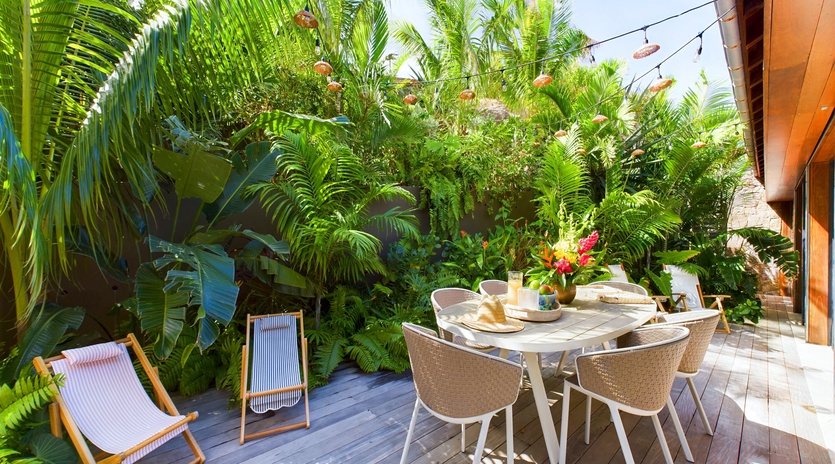 Enjoy tropical breakfast on your private deck surrounded by lush palms and vibrant blooms.