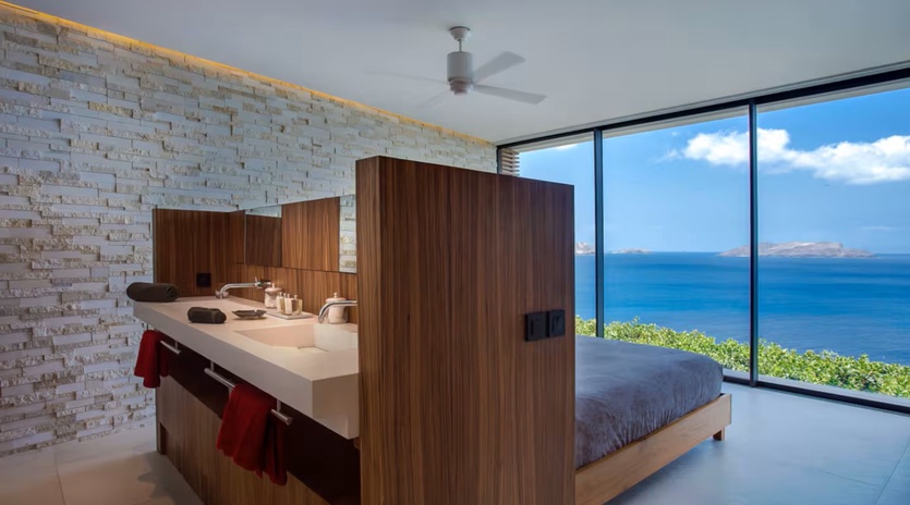 Wake to breathtaking ocean views through floor-to-ceiling windows in this modern coastal sanctuary. Open-concept design blends contemporary style with serene seaside living for an unforgettable getaway.