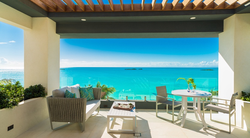 Your private terrace overlooks endless turquoise water, perfect for morning coffee or sunset dining in paradise.