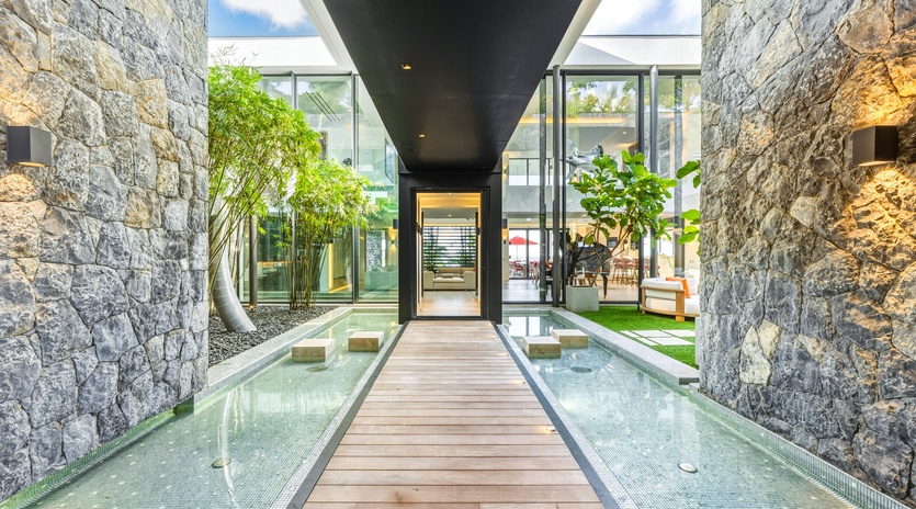 Walk across the elegant wooden bridge over crystal-clear water as you enter this stunning contemporary retreat.