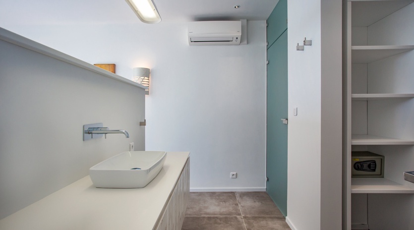 Step into your sleek modern bathroom with contemporary vessel sink, premium fixtures, and climate-controlled comfort for ultimate relaxation.