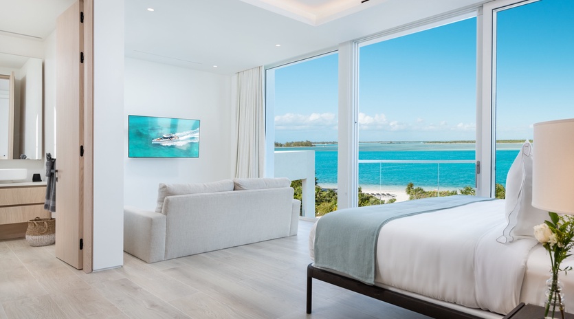 Wake up to breathtaking turquoise waters framing your suite. Pristine finishes, soothing coastal tones, and floor-to-ceiling windows invite endless ocean views into your personal retreat.