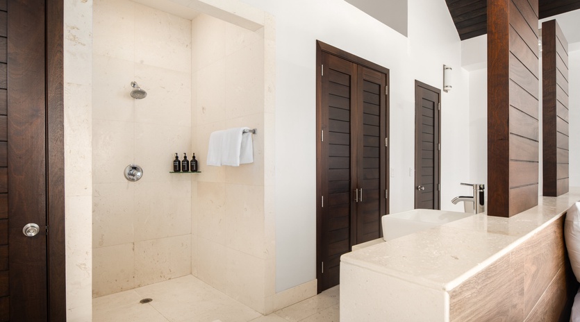 Step into your spa-like sanctuary with a spacious walk-in shower and elegant stone finishes that create a serene retreat.