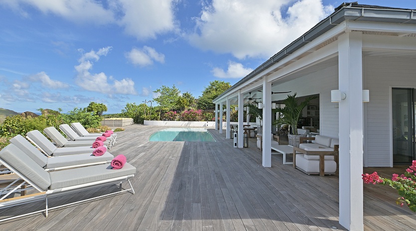 Soak up the tropical sunshine on your private deck, where comfortable loungers and refreshing pool create the perfect paradise retreat.