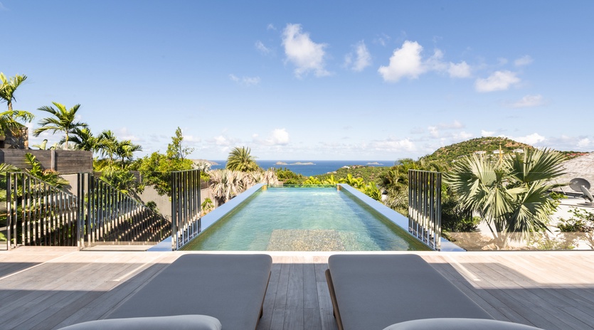 Stunning infinity pool with panoramic ocean views and tropical surroundings create the perfect paradise escape.