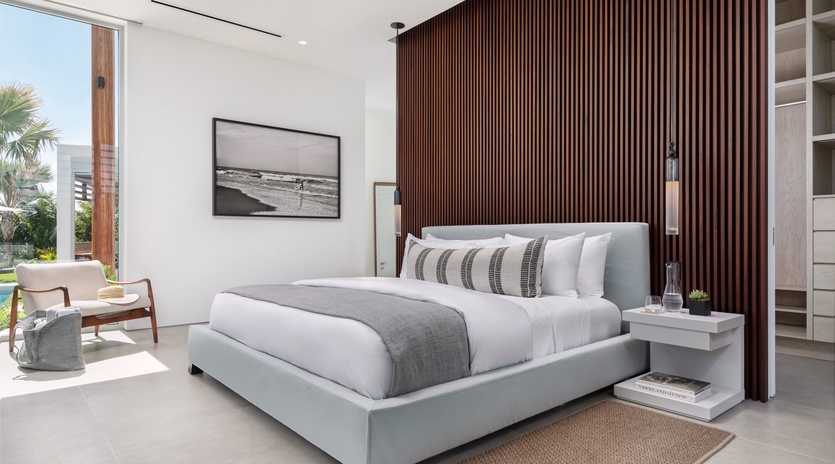 Drift off in your serene bedroom sanctuary, where crisp linens meet warm wood tones and natural light streams through floor-to-ceiling windows.