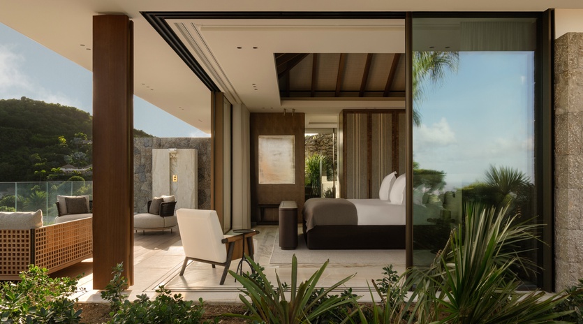Your sophisticated bedroom flows seamlessly onto a private terrace, where tropical gardens frame stunning mountain views beyond.