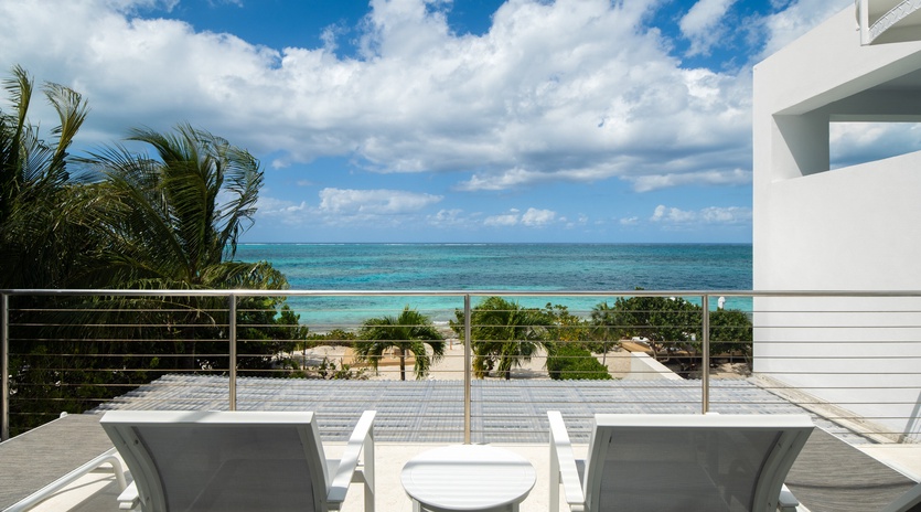 Stunning oceanfront balcony with pristine turquoise waters just steps away. Relax on comfortable loungers while tropical breezes refresh your soul.