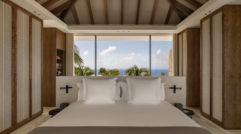 Wake up to stunning ocean views from your luxurious bed, where natural textures and modern comfort create your perfect tropical retreat.