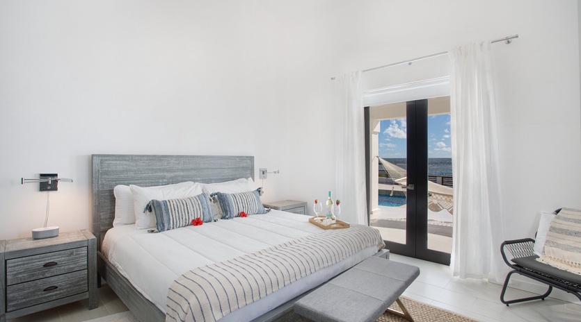 Wake up to stunning sea views from your bright, serene bedroom. Crisp linens, coastal-inspired decor, and direct access to your private balcony create a peaceful retreat.