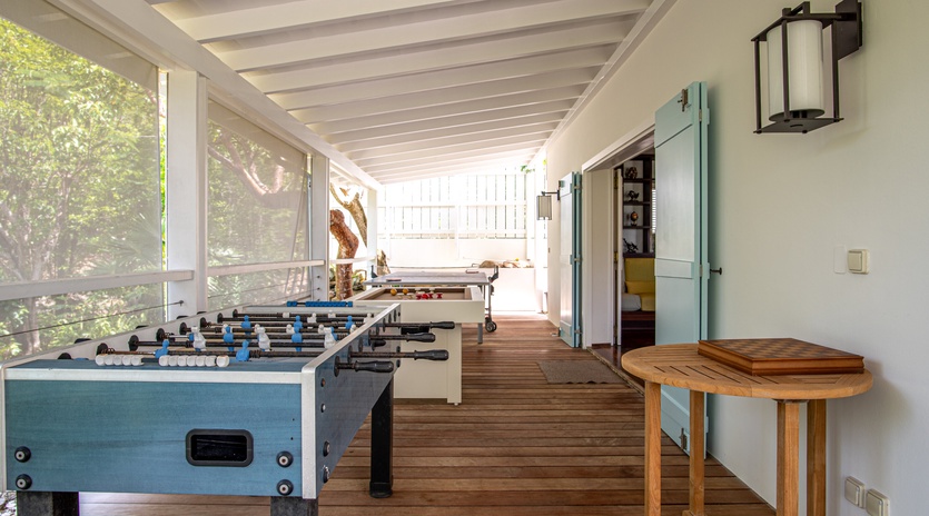 Challenge friends to foosball on your covered terrace, where wooden floors and garden views create the perfect game room atmosphere.