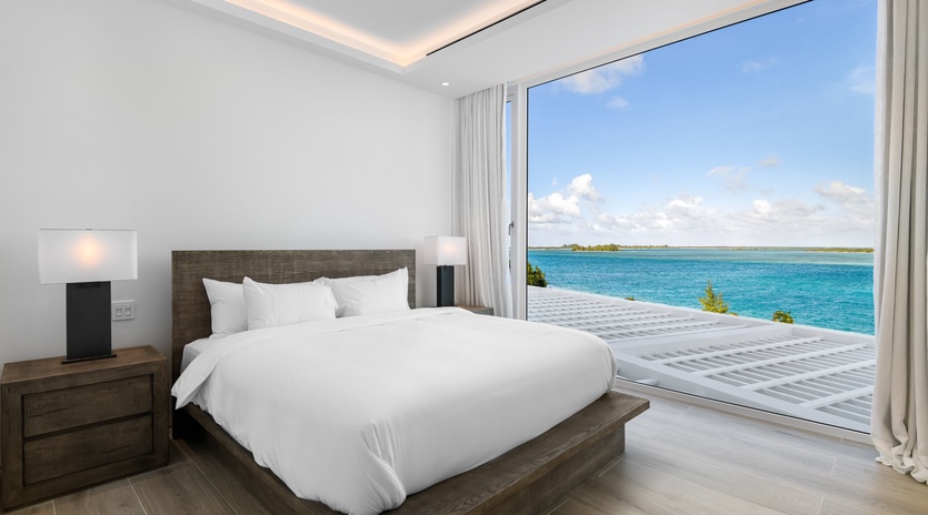 Wake up to breathtaking ocean views from your luxurious bedroom, where floor-to-ceiling windows frame endless turquoise waters.